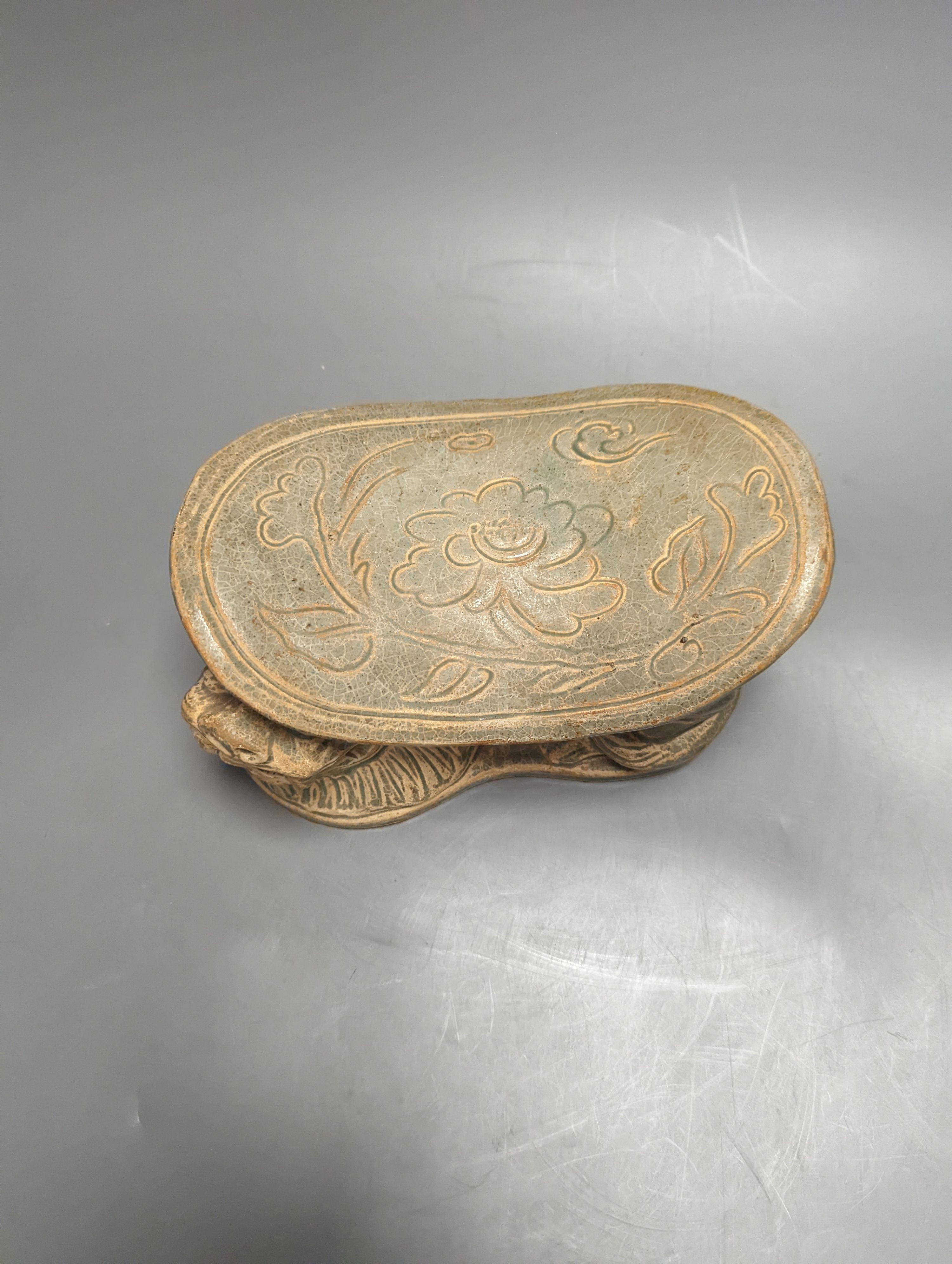 A Chinese celadon glazed pillow, width 20cm